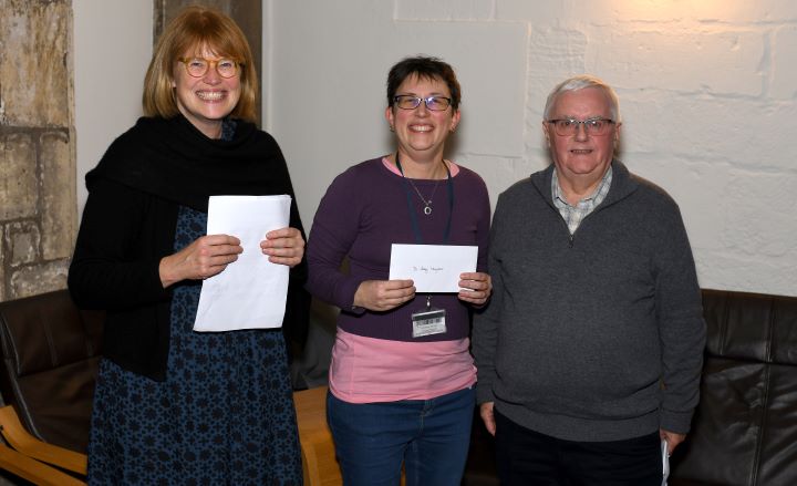 pictured from L-R are Elizabeth Tyler (head of CMS), Aleks McClain (Aubrey's supervisor, accepting the award in absentia), and Richard Dobson, Mark's partner who oversees the award.